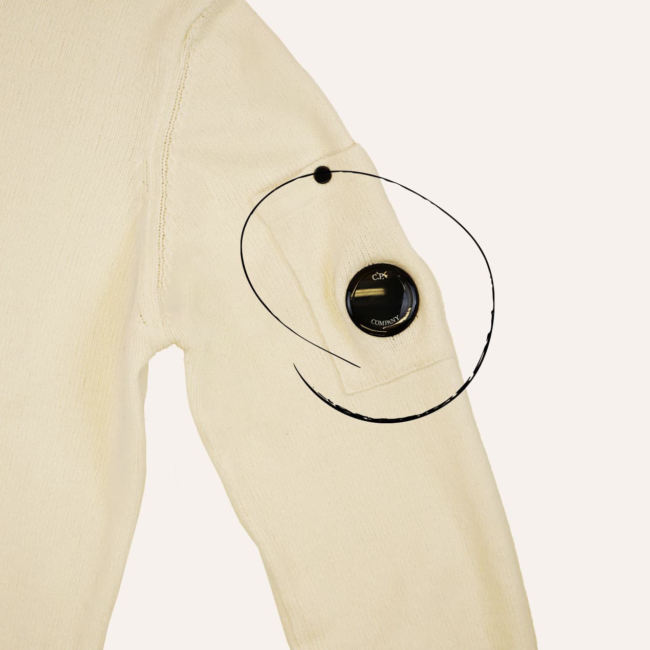 Example 1: C.P. Company lens reattached to the sweater sleeve after elastic replacement.