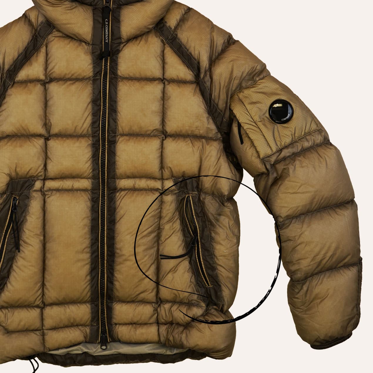 Example 3: Ochre DD Shell jacket with a hole in the panel next to the pocket zip.
