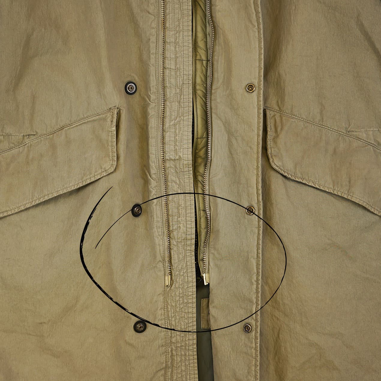 Example 4: C.P. Company parka with damaged central zip.