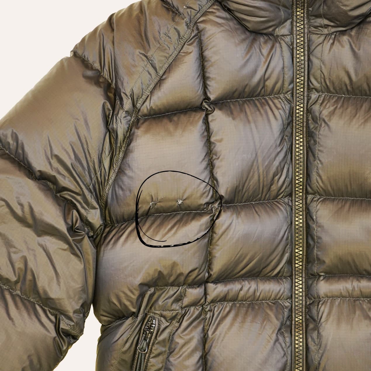Example 7: Brown DD Shell jacket with two holes on a chest panel.