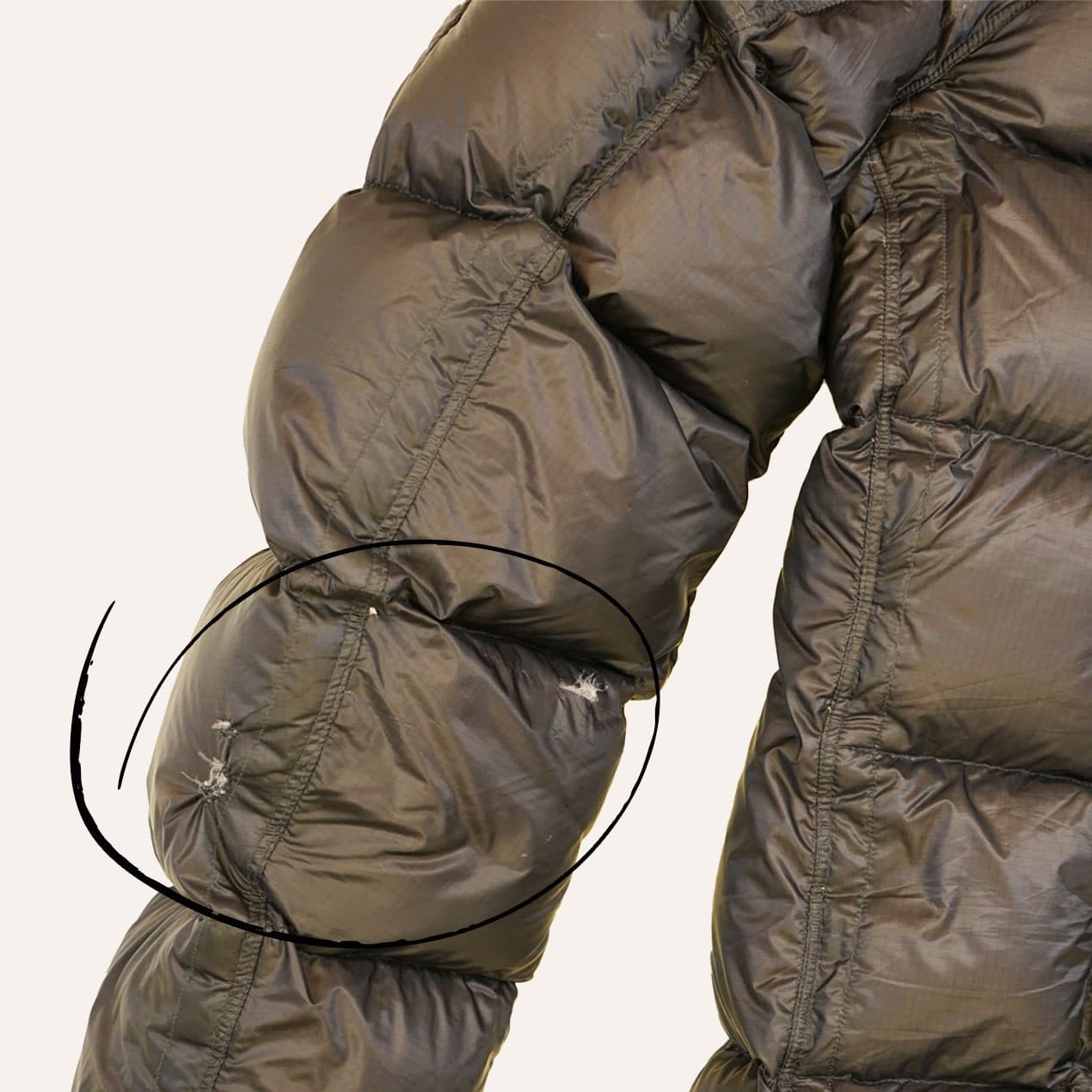 Example 8: Brown C.P. Company jacket with two damaged panels on the sleeve.