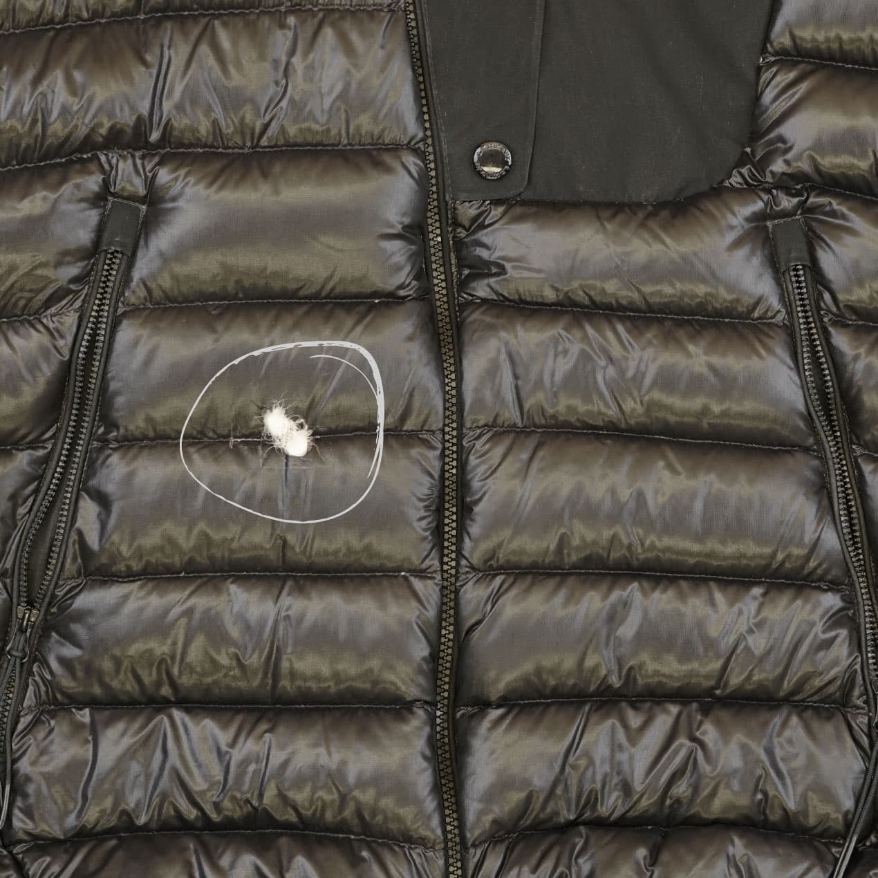 Example 9: Black DD Shell jacket with a hole across two front panels.